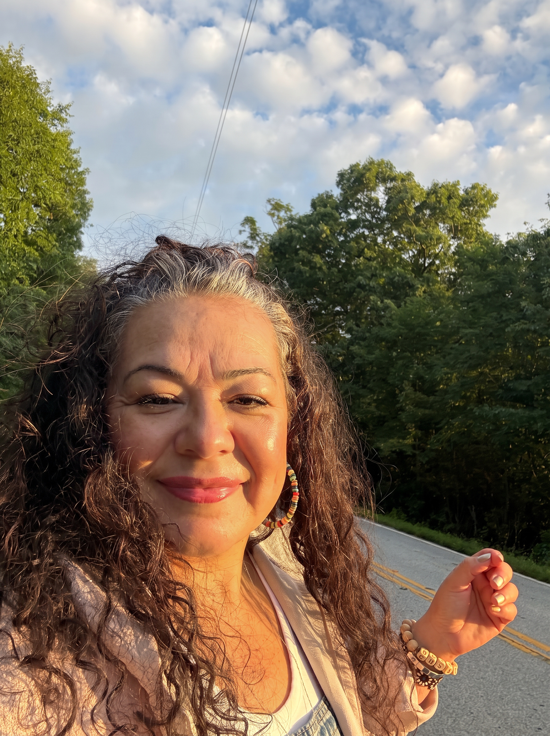 Yvette Farmer taking a selfie outdoors in golden-hour light